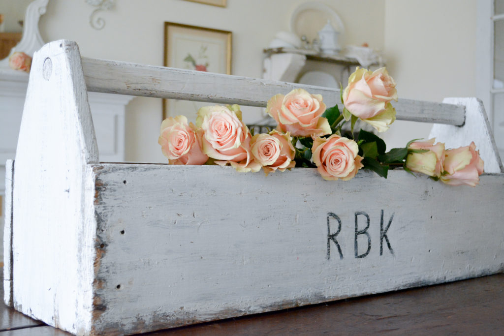 Roses in antique tool box painted white