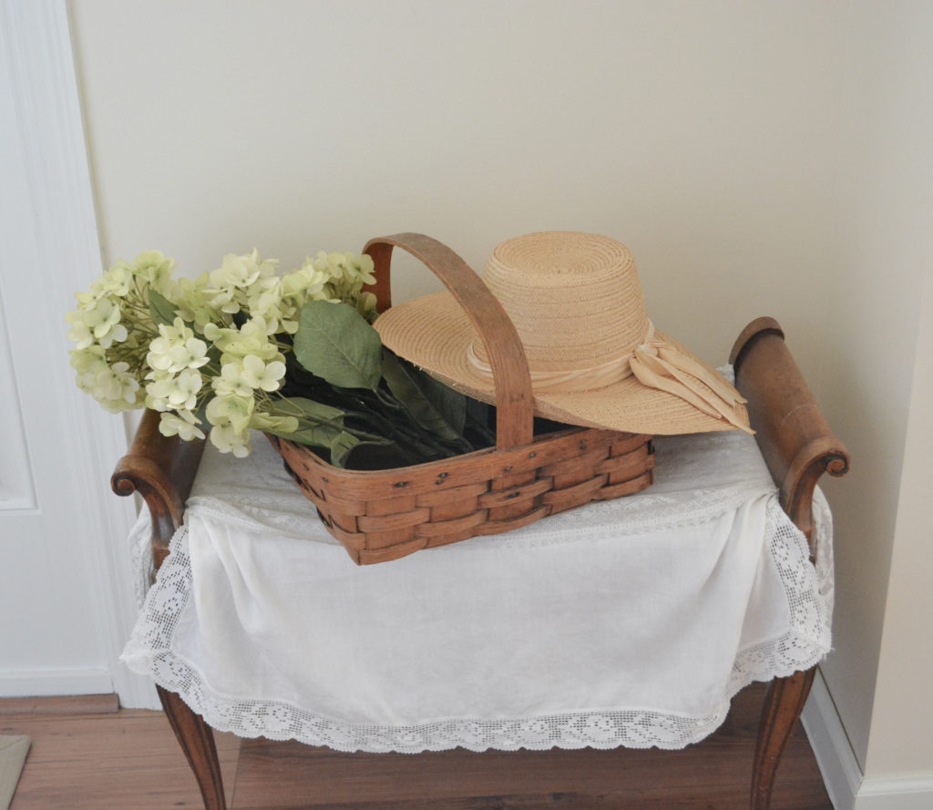 vintage basket with hydrangeas and straw hat