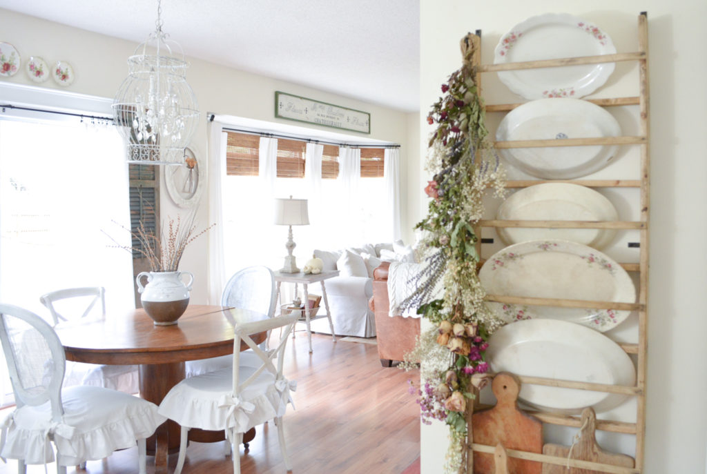 Cottage style room with a DIY dried floral hanging on a rustic plate rack.
