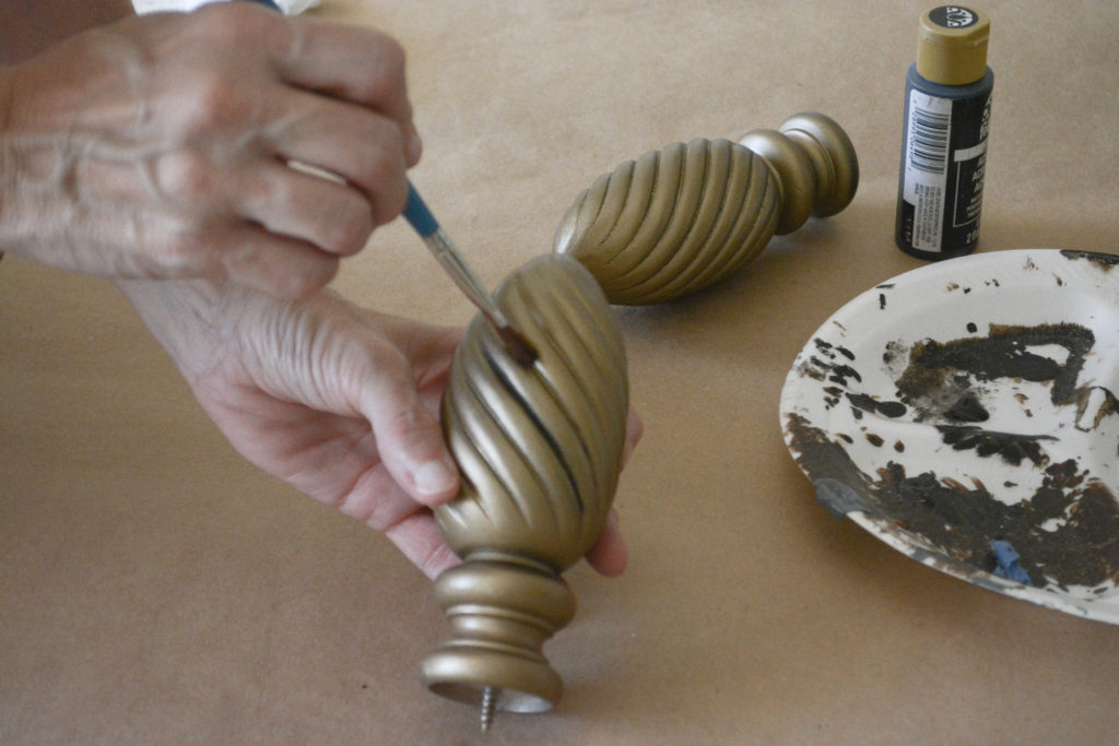 Creating an antique brass finish on curtain finials.