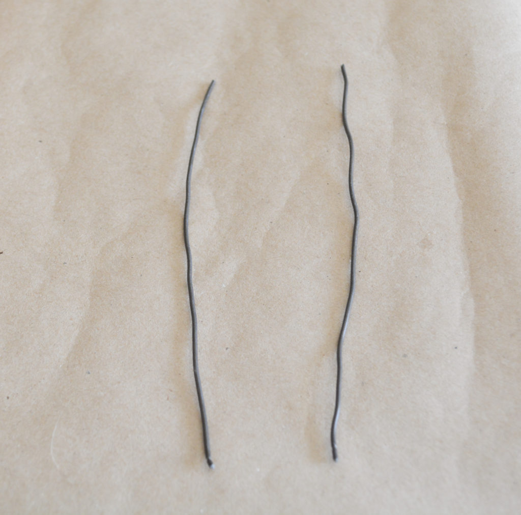 wrapping wire around a nail template to make angel wings