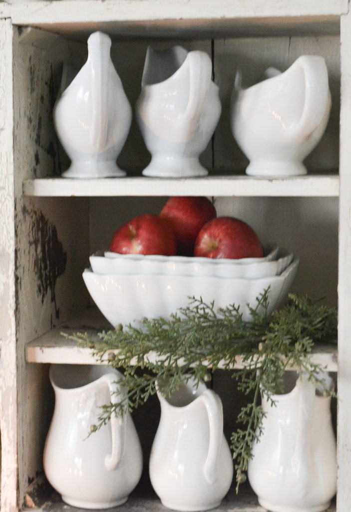 french farmhouse kitchen shelves with ironstone and red and white transferware