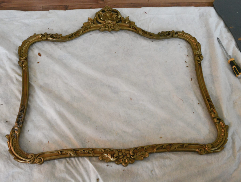 vintage mirror frame turned into fireplace screen