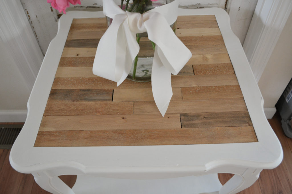 a table painted white with wood top