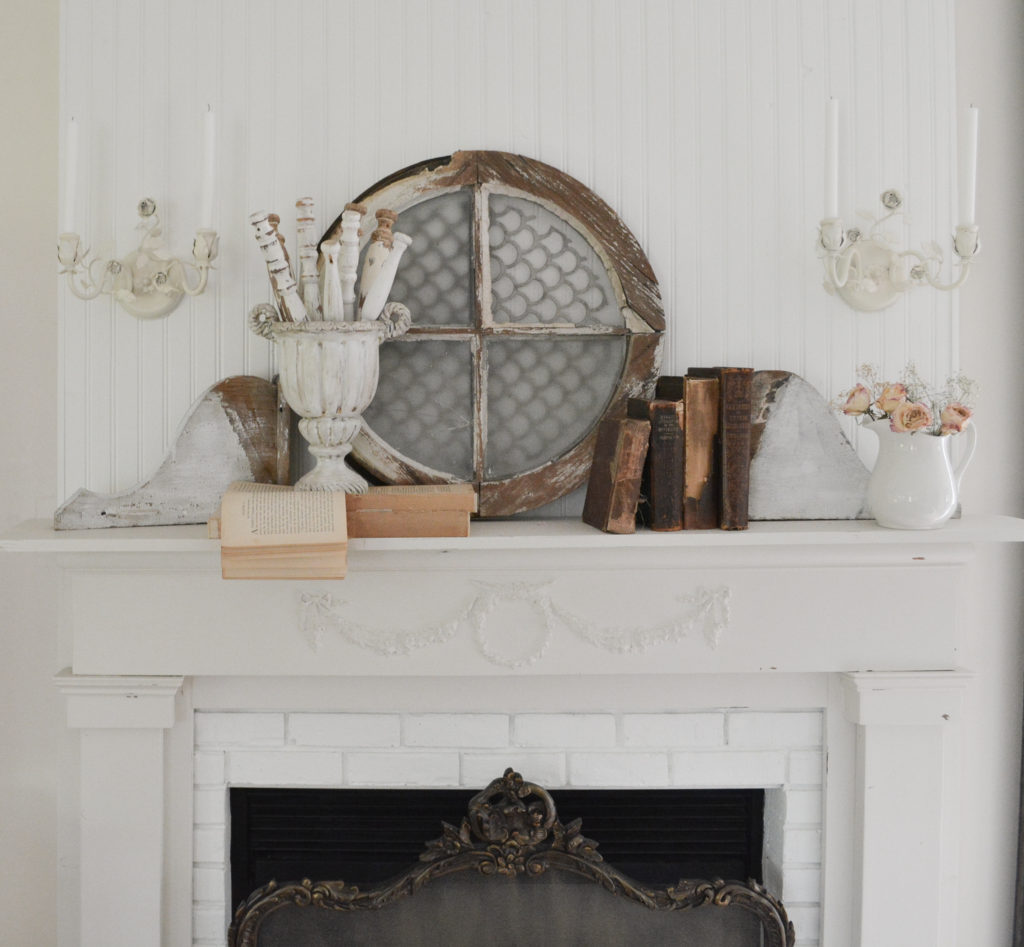 DIY fireplace with vintage light sconces turned into candle holders