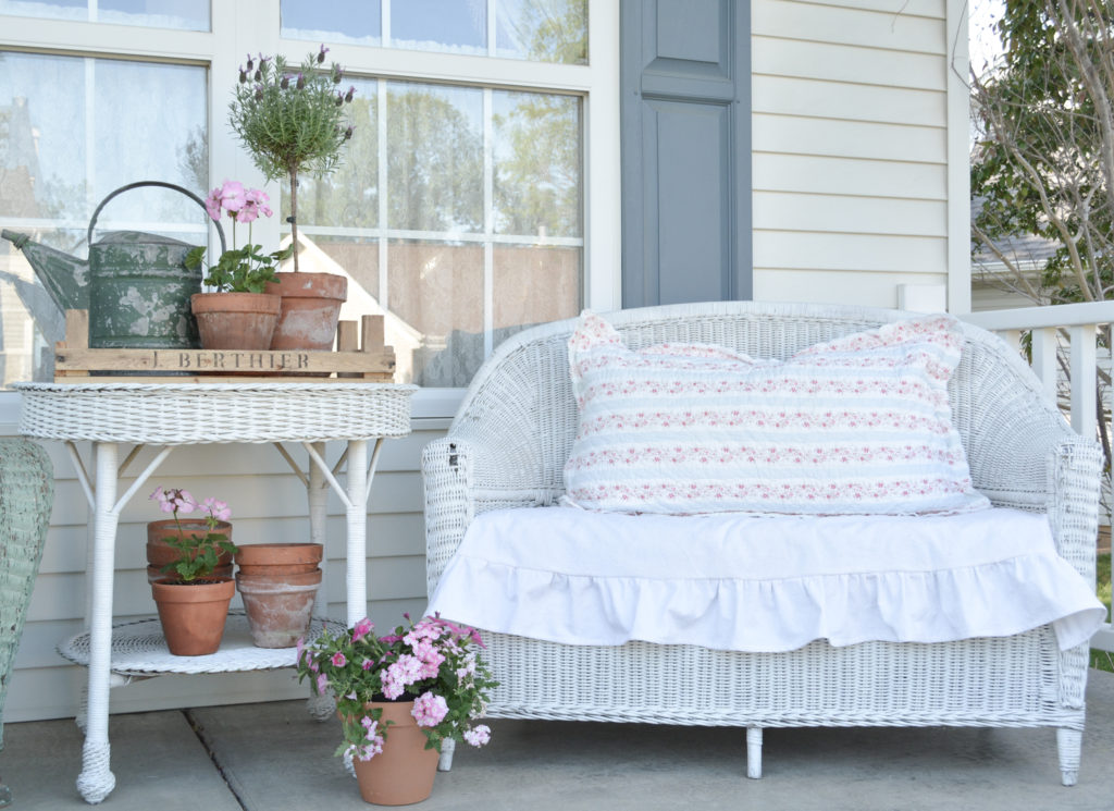 vintage wicker loveseat with ruffled seat cushion