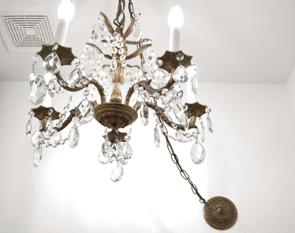 vintage chandelier swagged from wall