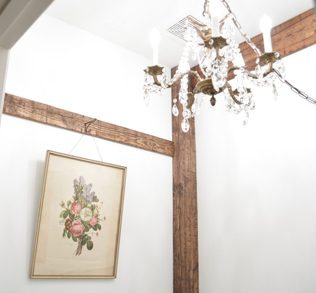 DIY faux corner beam with vintage print and vintage chandelier