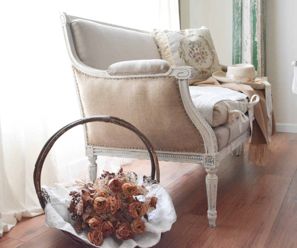 french settee and basket of dried roses