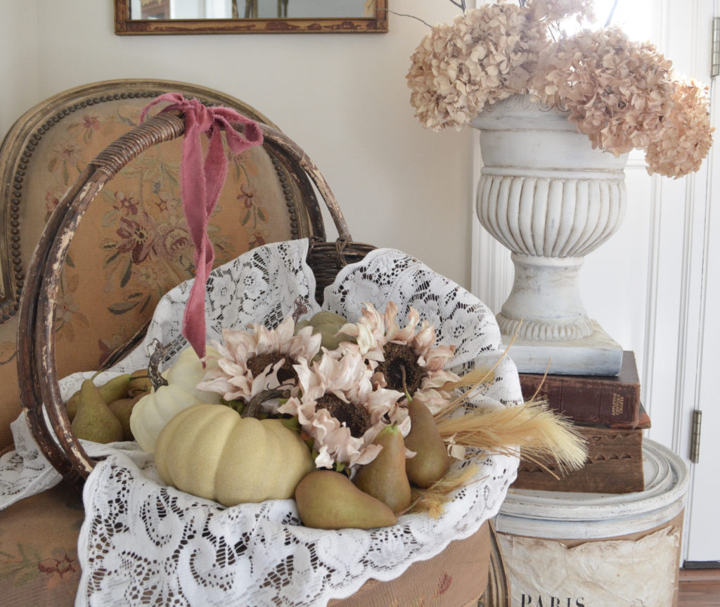 A basket filled with pears and pumpkins