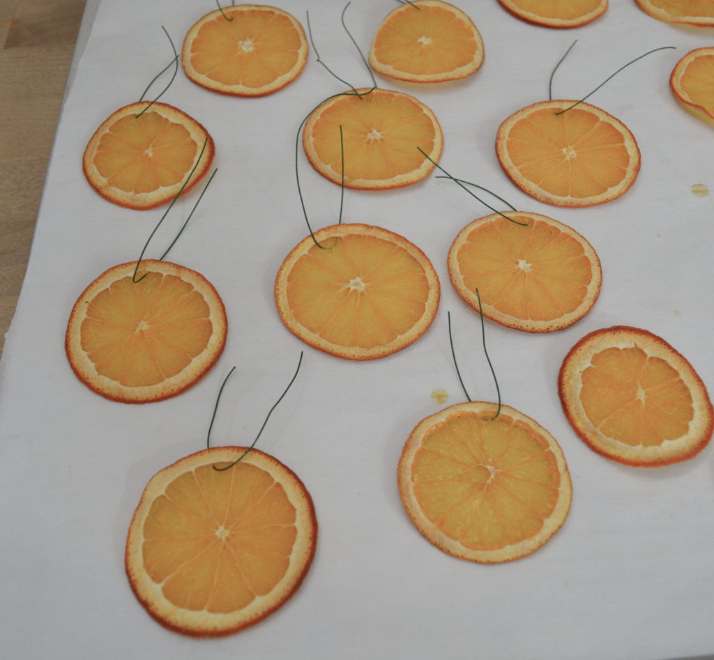 preparing dried orange slices for hanging