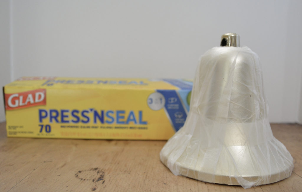 using plastic wrap for a paper mache bell