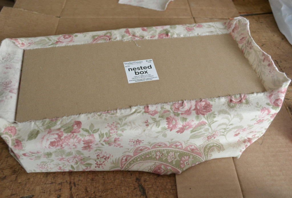 gluing fabric to make a fabric covered box