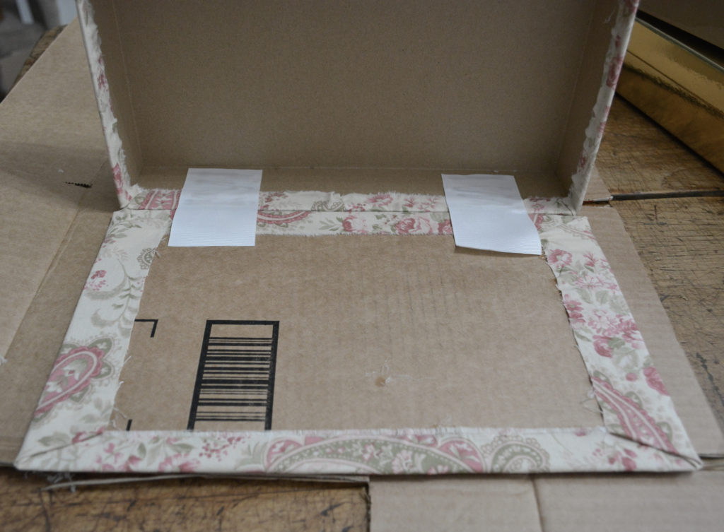 attaching a lid to a fabric covered box with ribbon