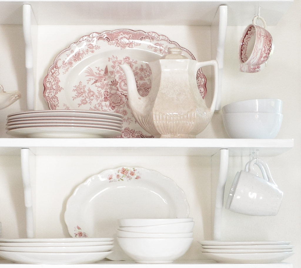 red and white transferware china on kitchen shelf
