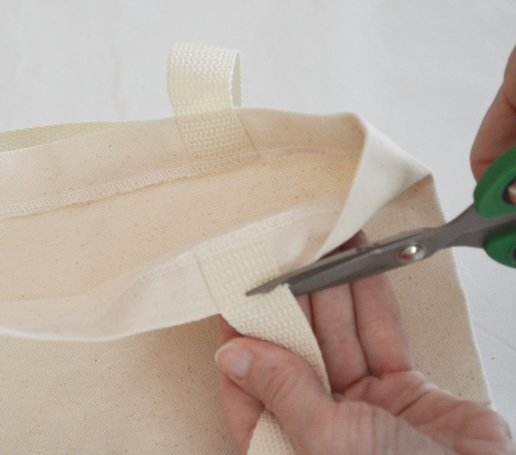 cutting the handles off a tote bag