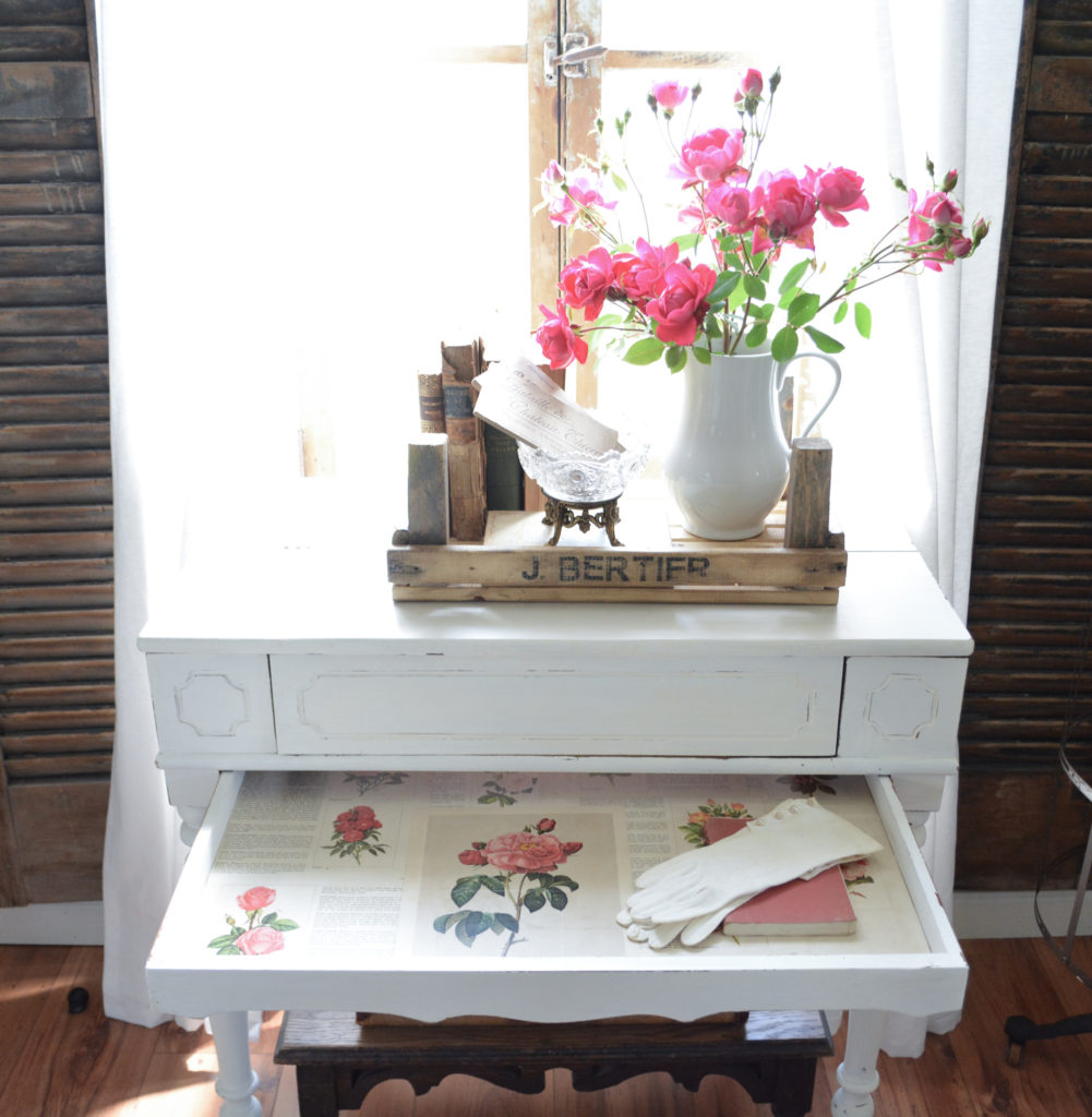 Old spinet desk with drawer lined in roses book pages