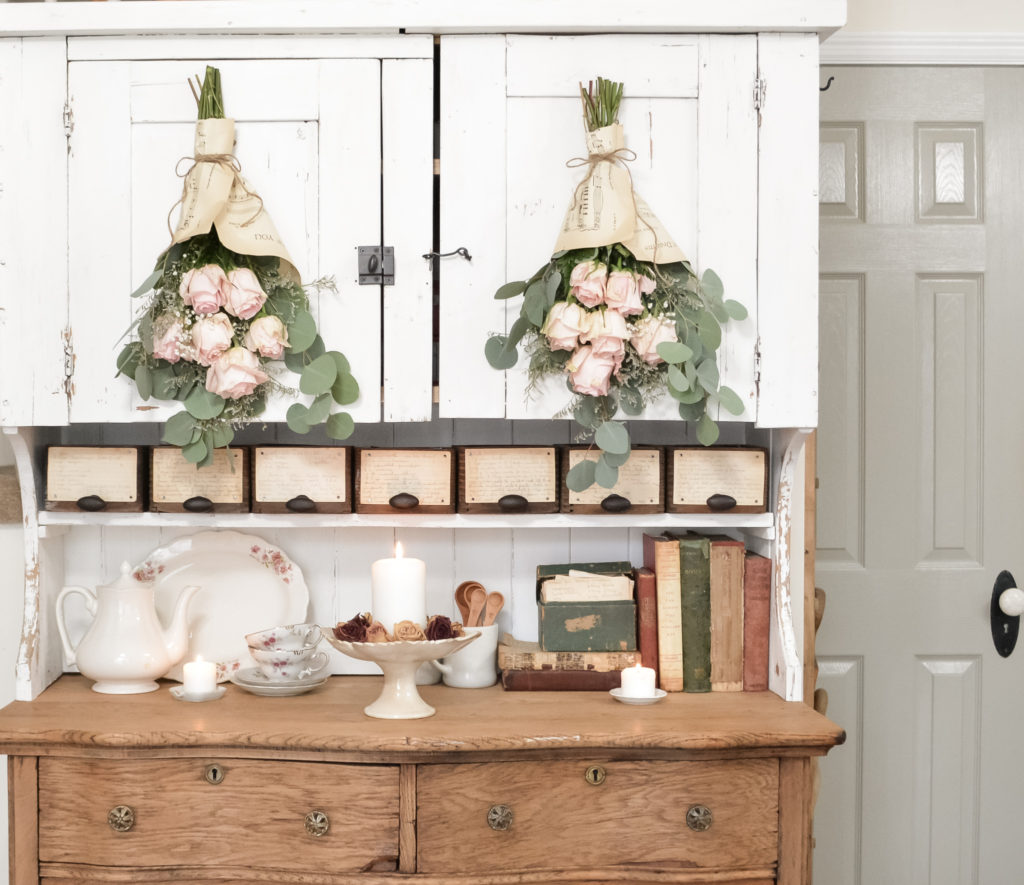 white chippy hutch top with dried roses