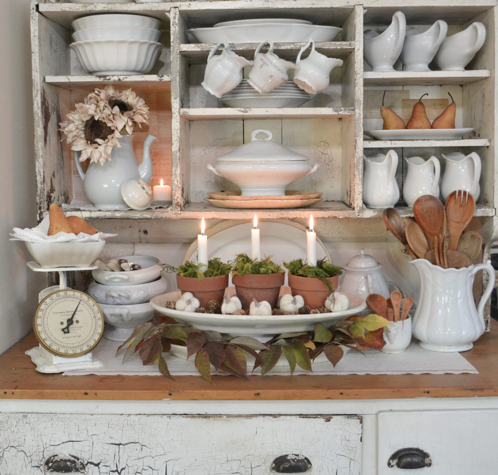 Hutch filled with ironstone and terracotta pot candle holders