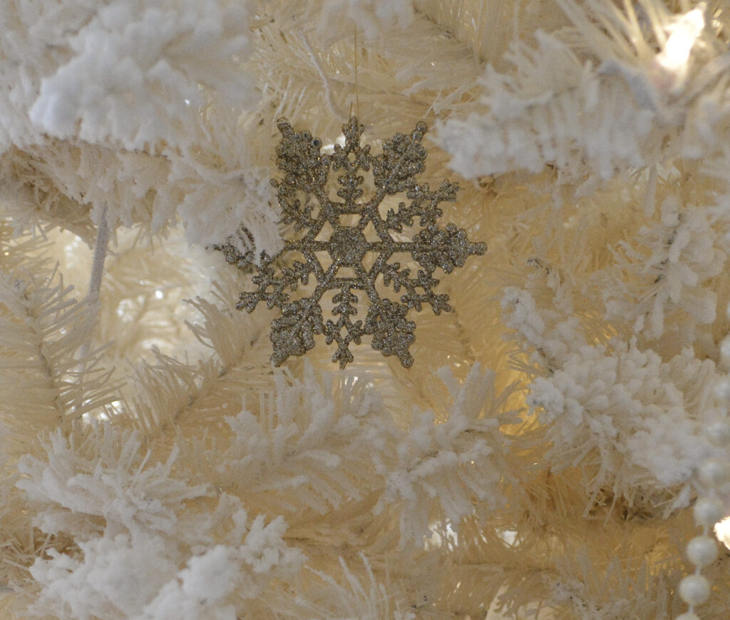 antique gold snowflake ornament used as a filler when decorating a Christmas tree