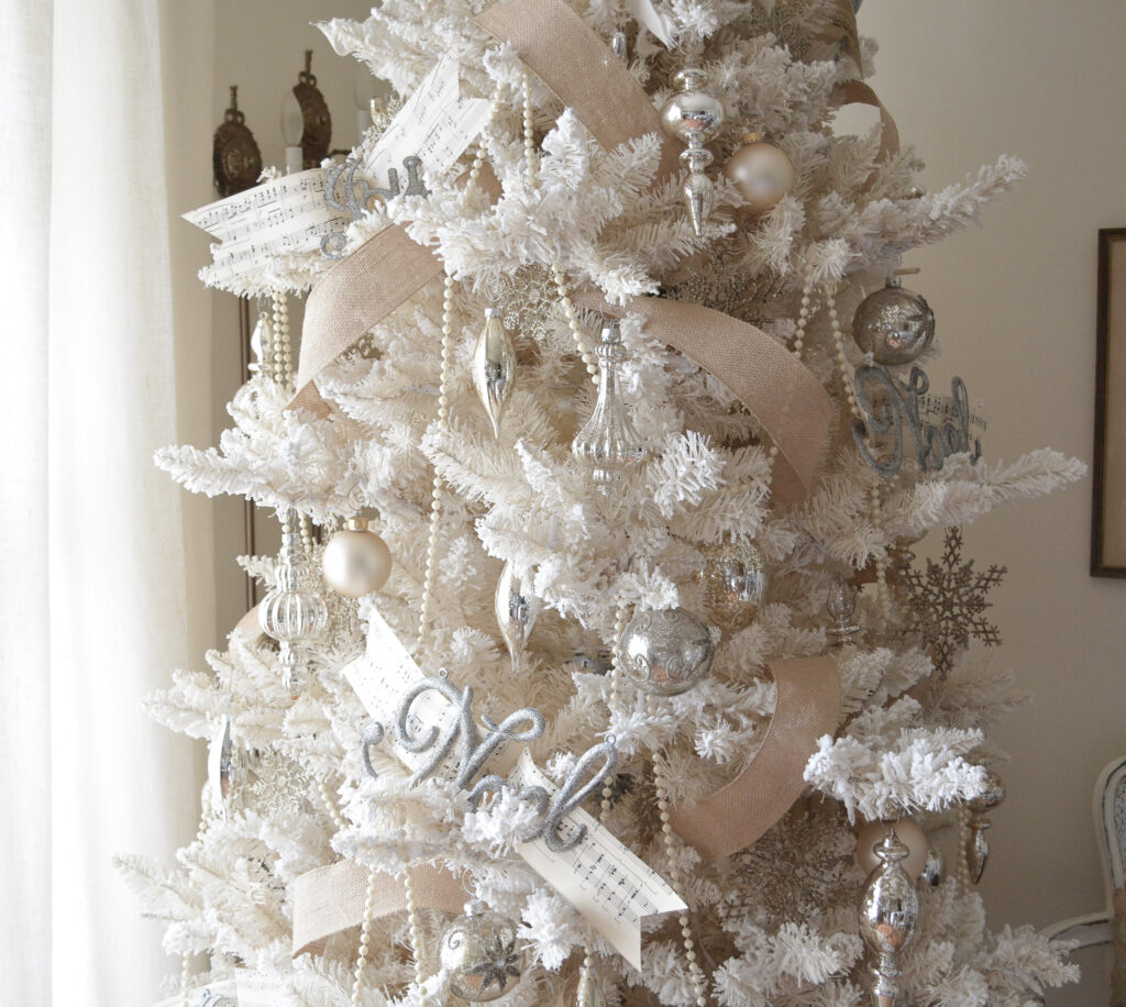 showing step 6 of the best order to decorate a Christmas tree is adding statement ornaments