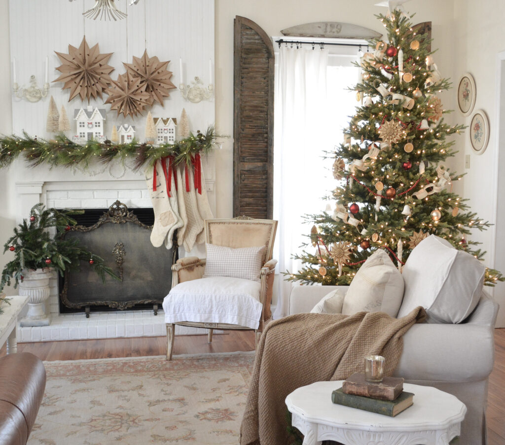 Paper bag stars and glitter hiuses on Christmas fireplace mantel